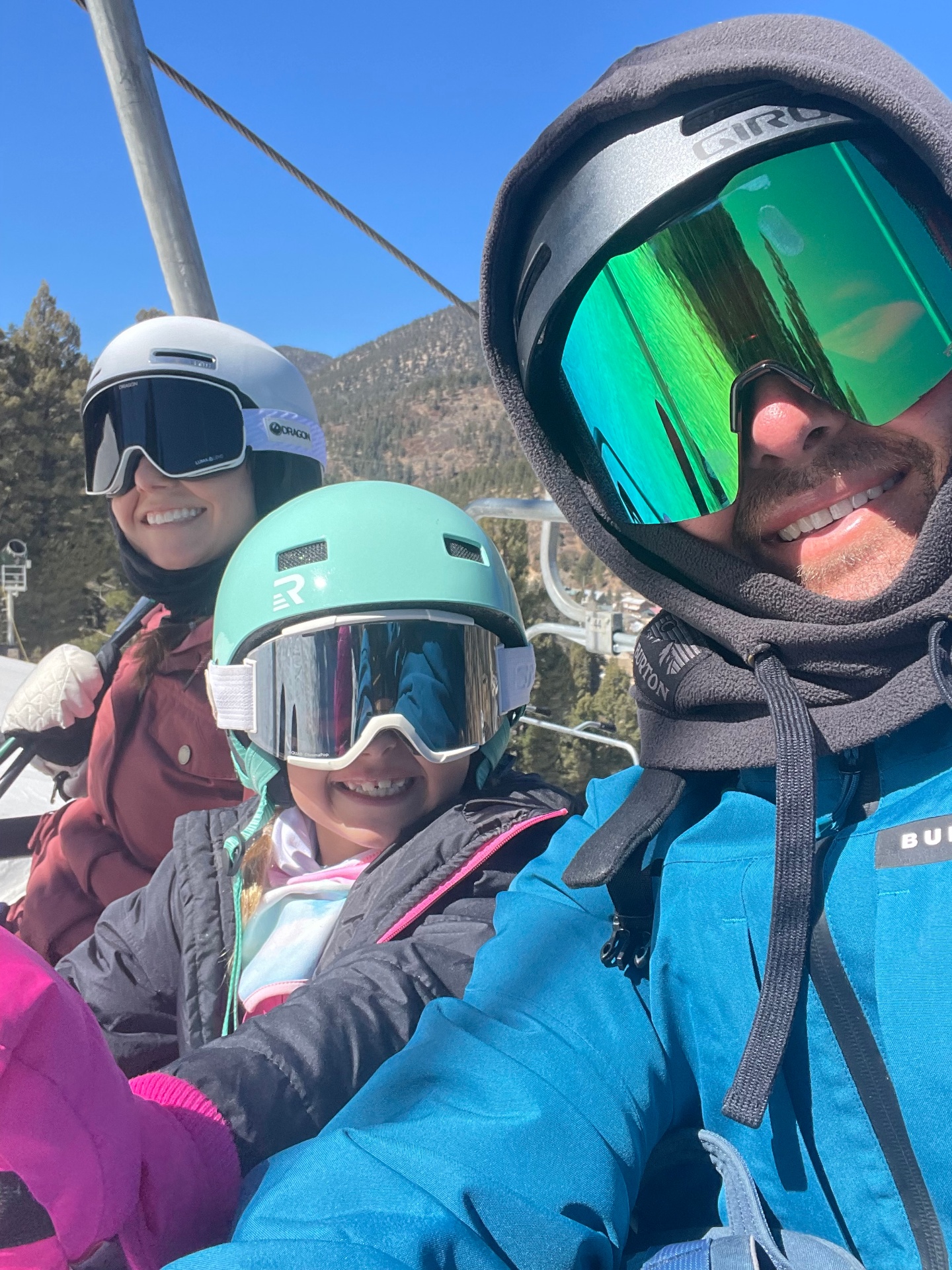 Clint Wallace with his wife Sarah and daughter on a ski lift